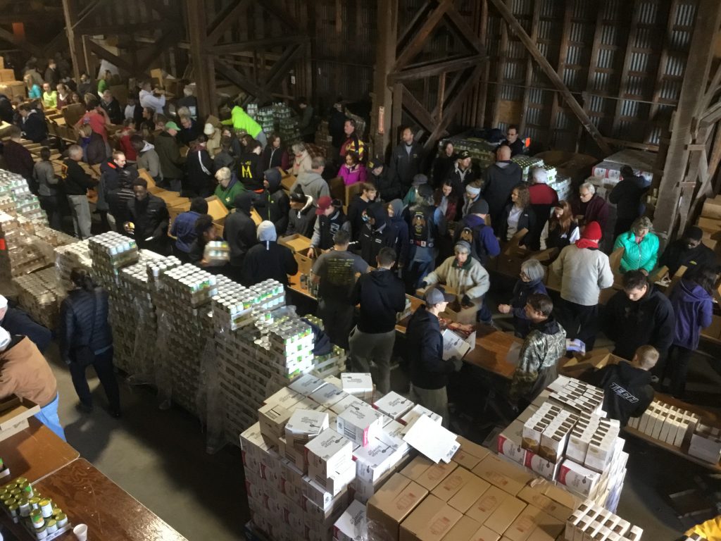 Hundreds of volunteers help pack full family meals for our annual Thanksgiving for Thousands event in Selbyville, DE.