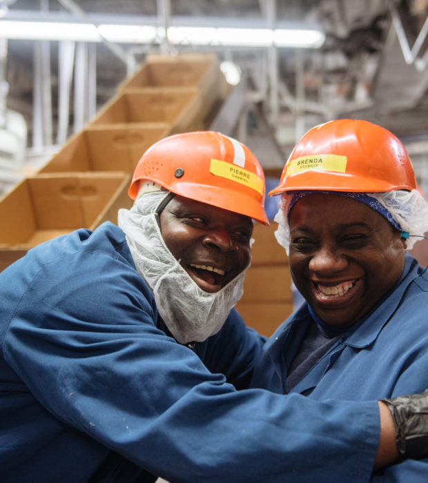 two men smiling in work gear