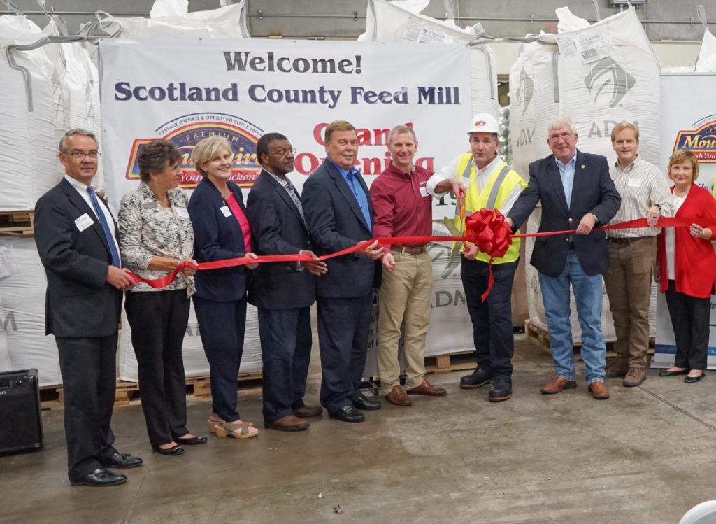 Our Executive Team and guests prepare to cut the ribbon at the grand opening of our Scotland County Feed Mill.